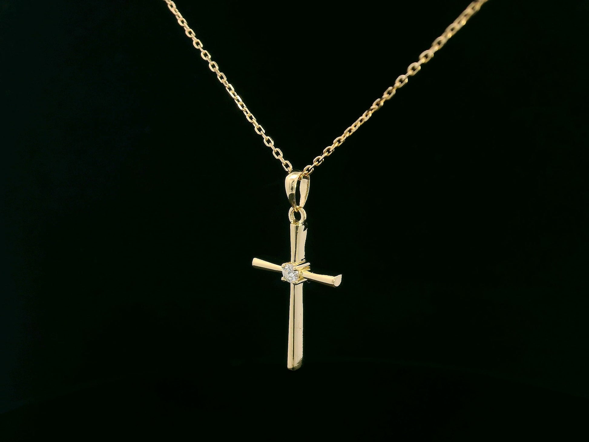18K yellow gold cross pendant with 0.05 carat center diamond, minimalist design, chain not included