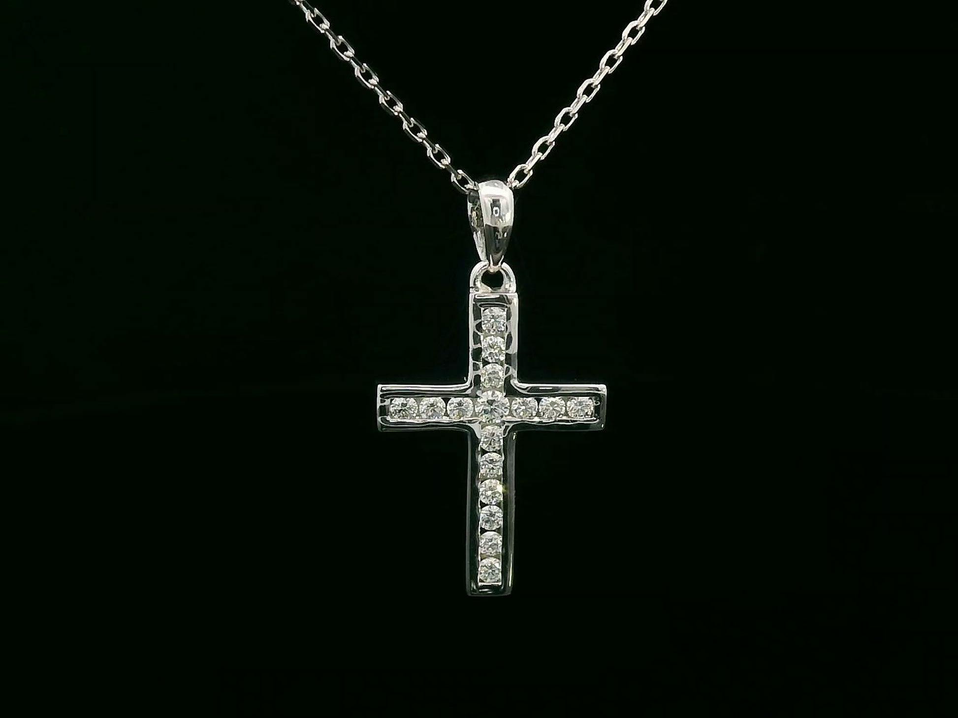 18K gold cross pendant with 0.20 carat round diamonds, religious charm on black background

