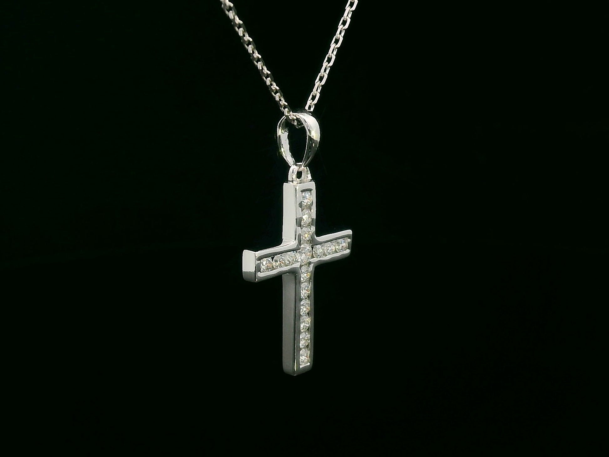 18K gold cross pendant with 0.20 carat round diamonds, religious charm on black background

