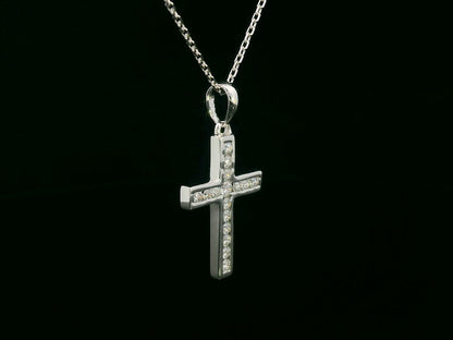 18K gold cross pendant with 0.20 carat round diamonds, religious charm on black background

