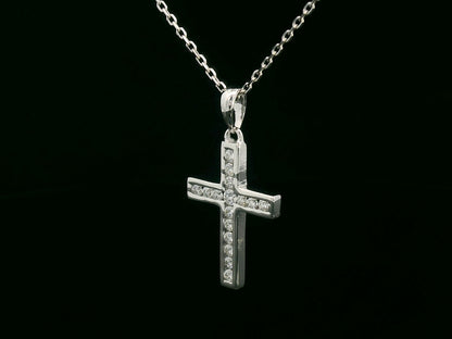 18K gold cross pendant with 0.20 carat round diamonds, religious charm on black background

