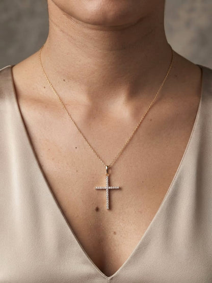 18K yellow gold diamond cross pendant featuring 0.26 carat natural round brilliant diamonds. Chain sold separately.