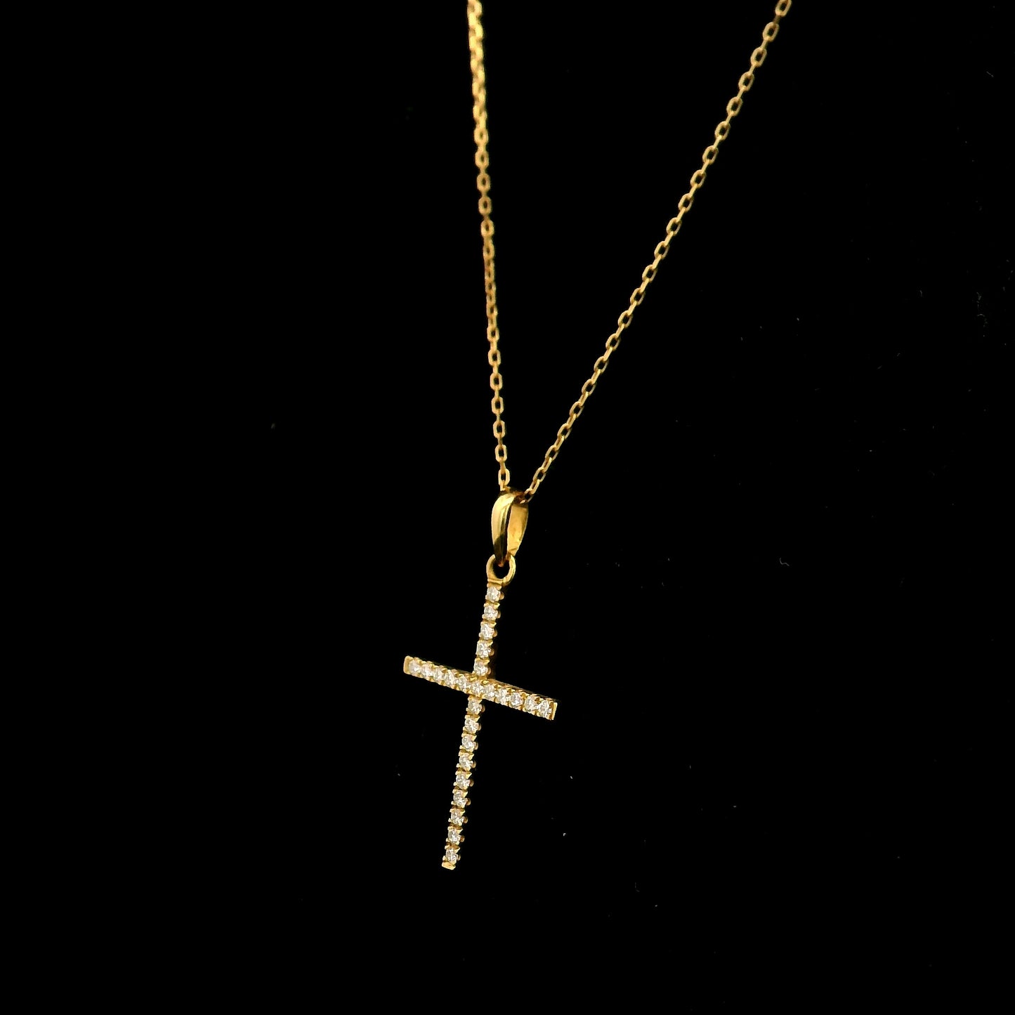 18K yellow gold diamond cross pendant featuring 0.26 carat natural round brilliant diamonds. Chain sold separately.