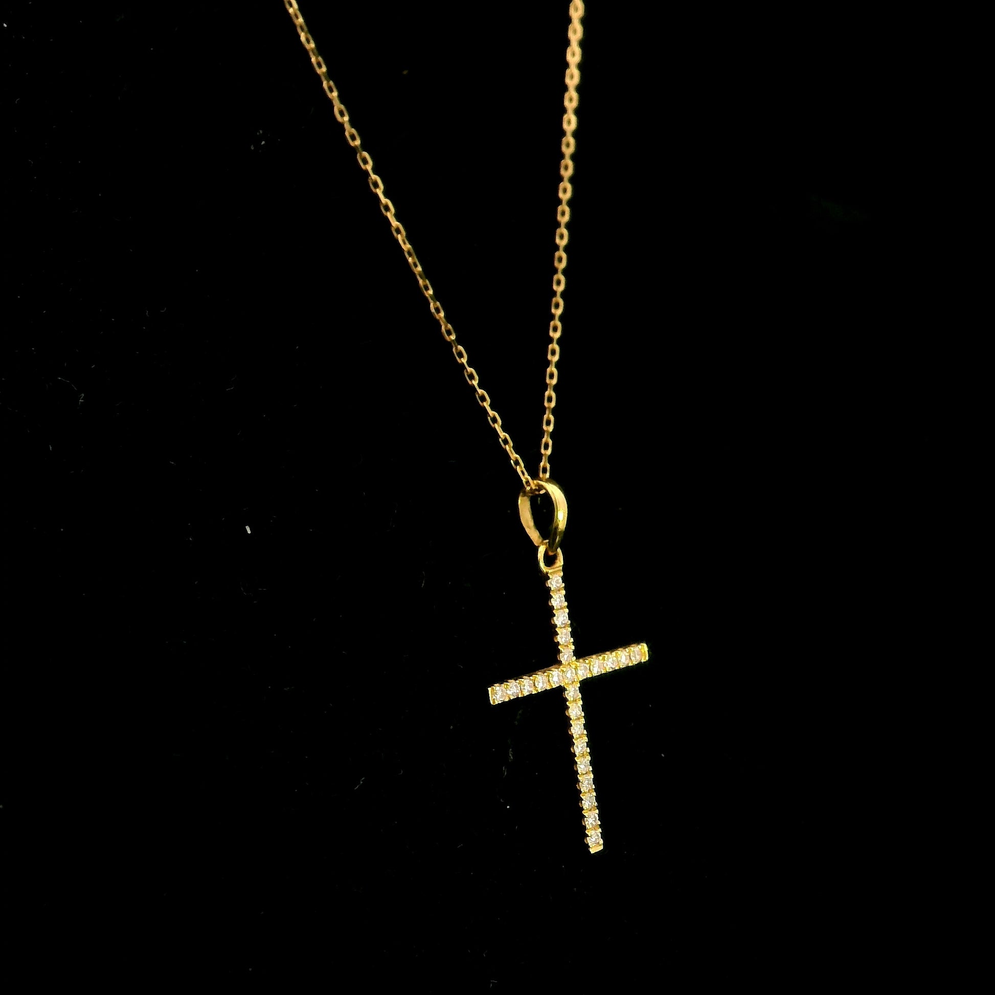 18K yellow gold diamond cross pendant featuring 0.26 carat natural round brilliant diamonds. Chain sold separately.