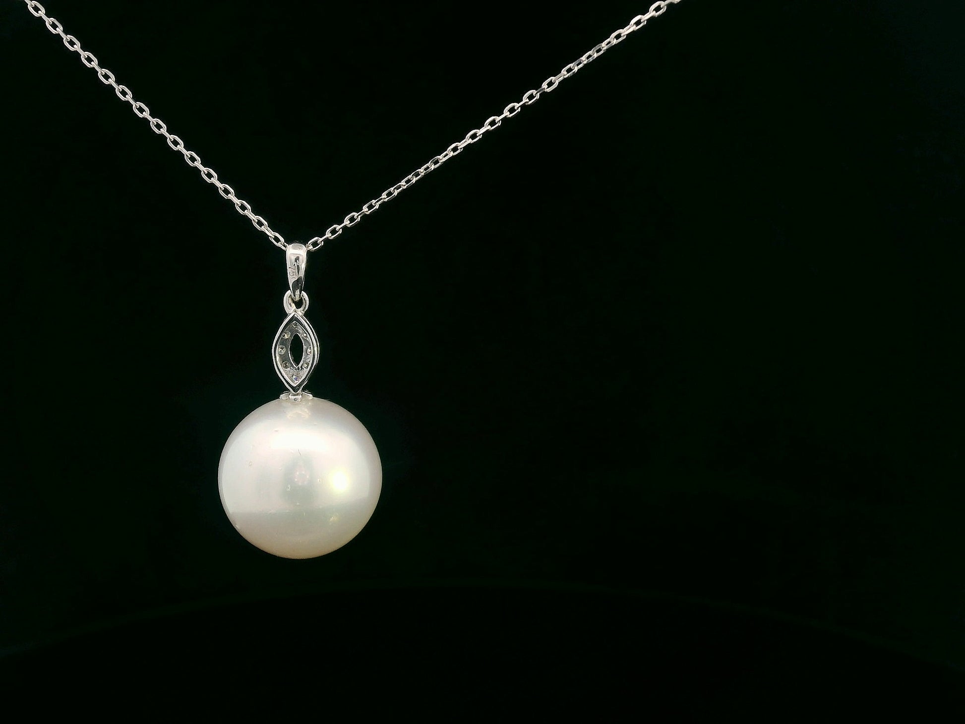Classic pearl pendant featuring marquise diamond accents