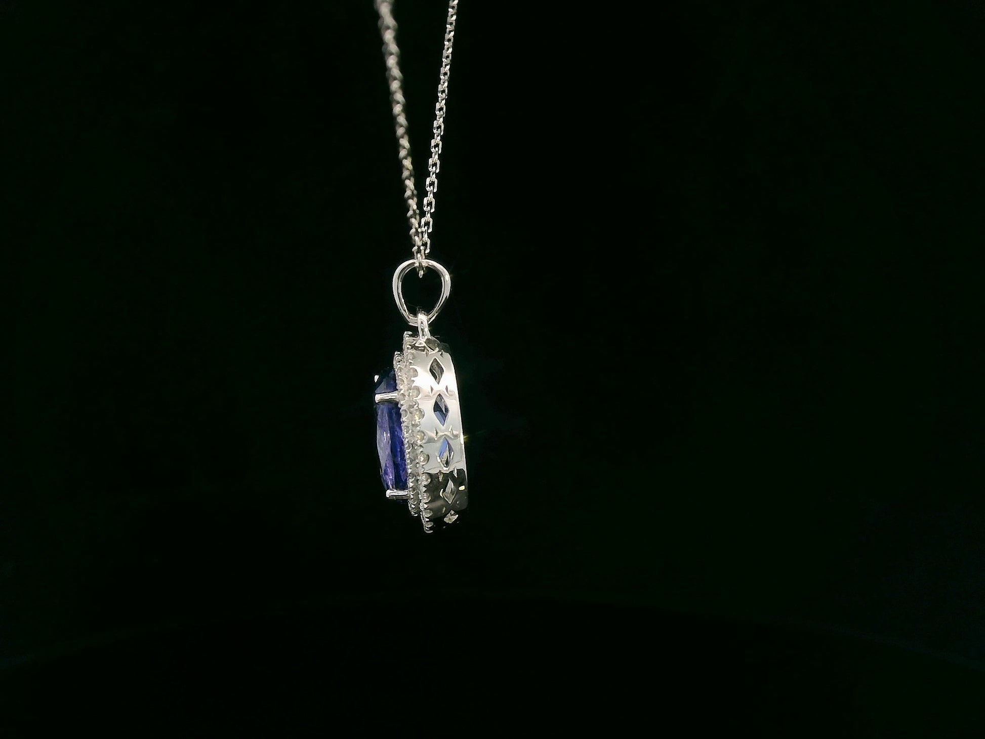 Tanzanite and diamond halo pendant in white gold