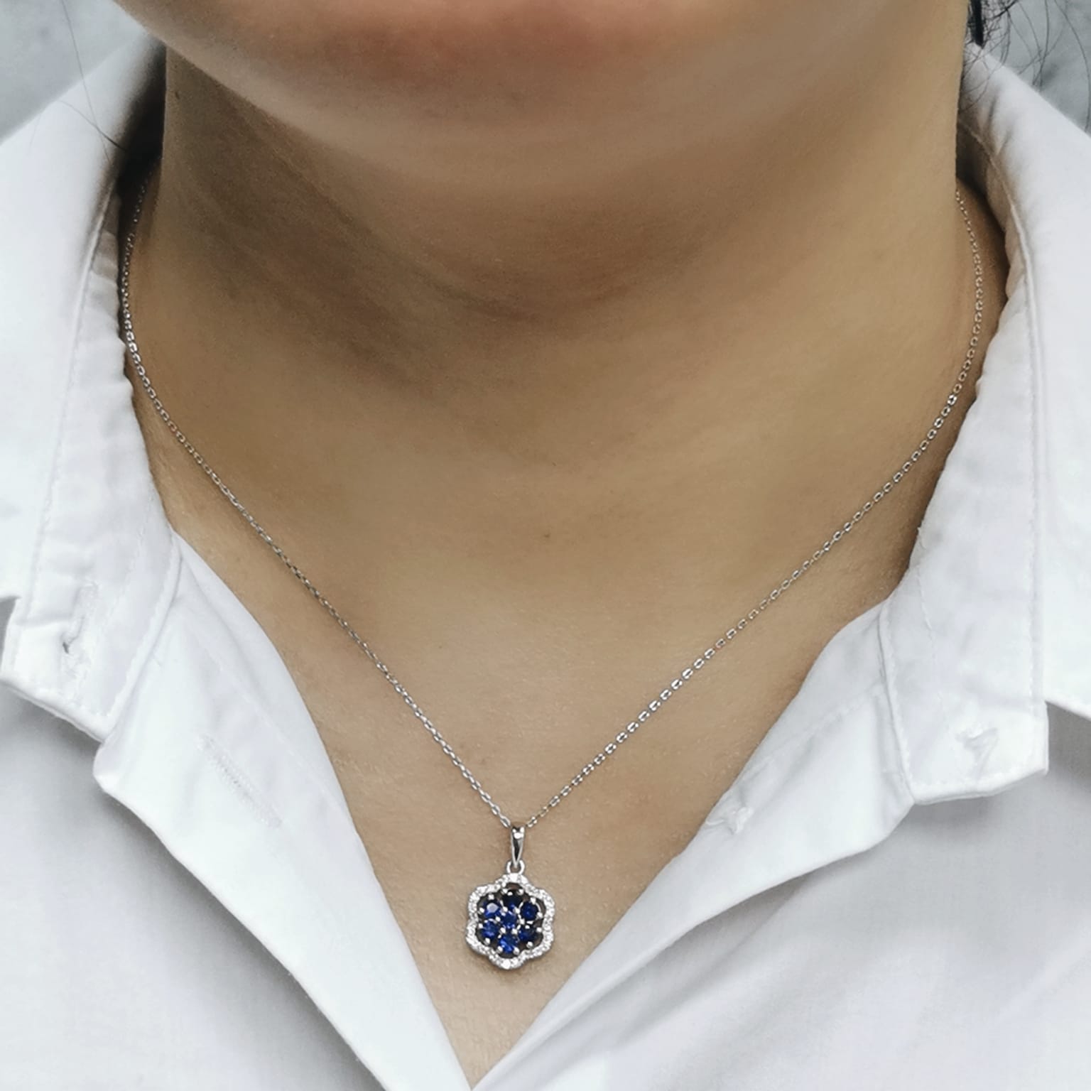 Delicate sapphire cluster pendant in floral design