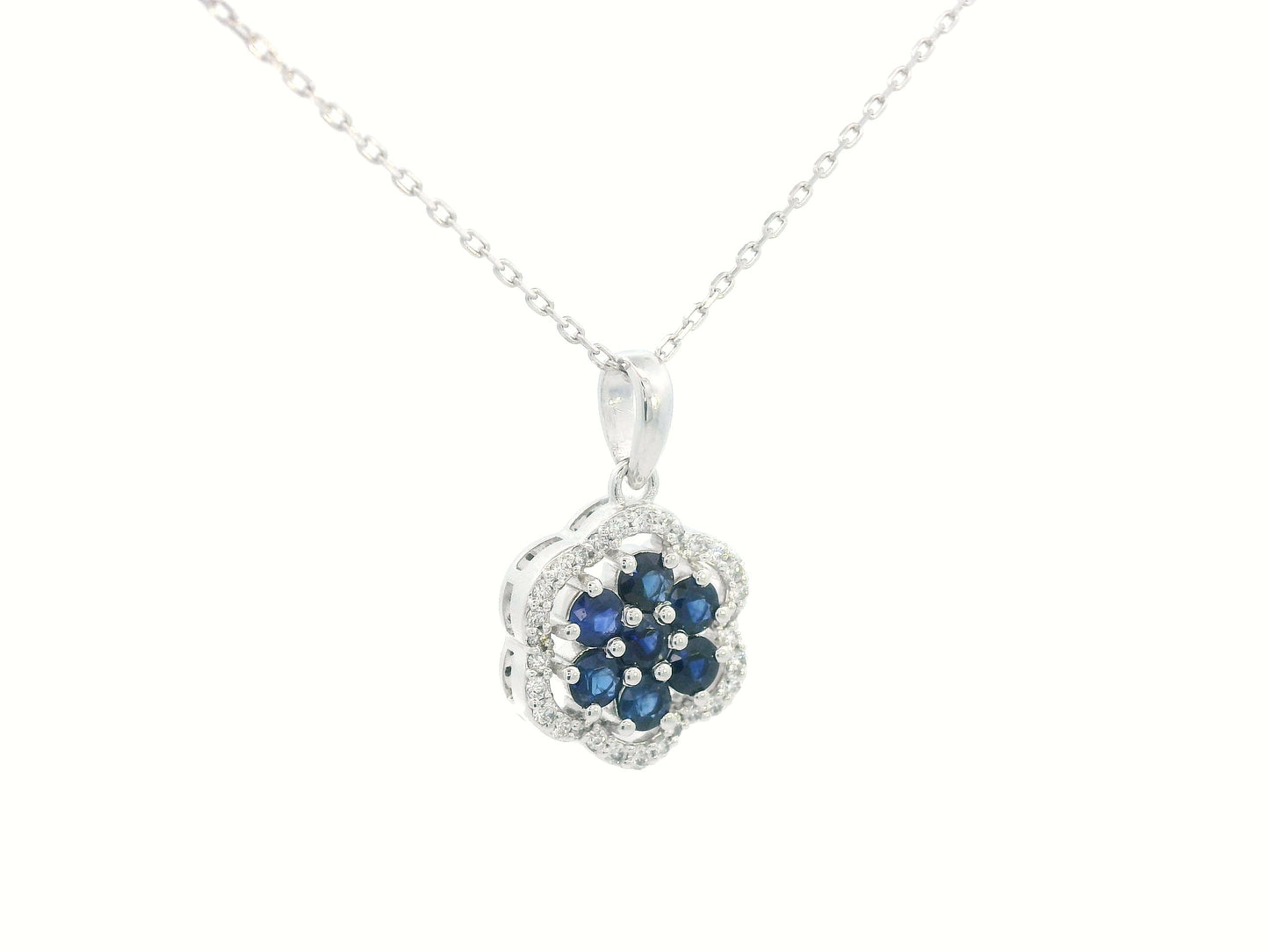 Elegant gemstone pendant featuring blue sapphires and diamonds