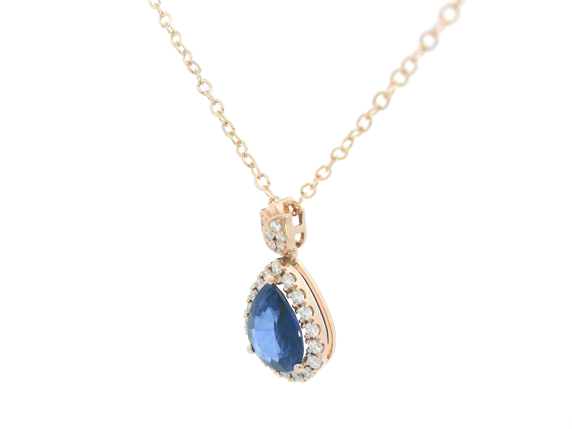 Elegant pear-cut sapphire pendant with floral-inspired diamond bail