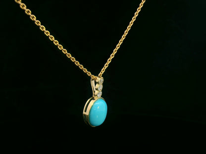 18K yellow gold pendant with 2.46ct oval turquoise and 0.14ct diamond accents.