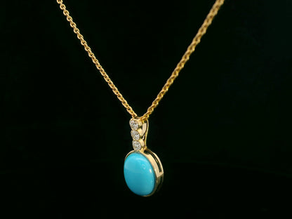 18K yellow gold pendant with 2.46ct oval turquoise and 0.14ct diamond accents.