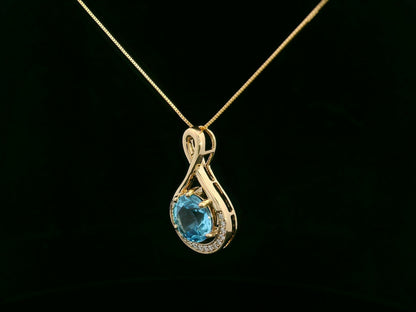 18k yellow gold pendant with 2.30 carat Swiss blue topaz center, diamond halo, and infinity-style bale