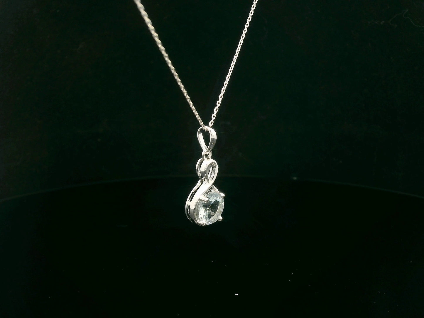 18k white gold pendant with 1.10-carat round-cut aquamarine in infinity-style bail design