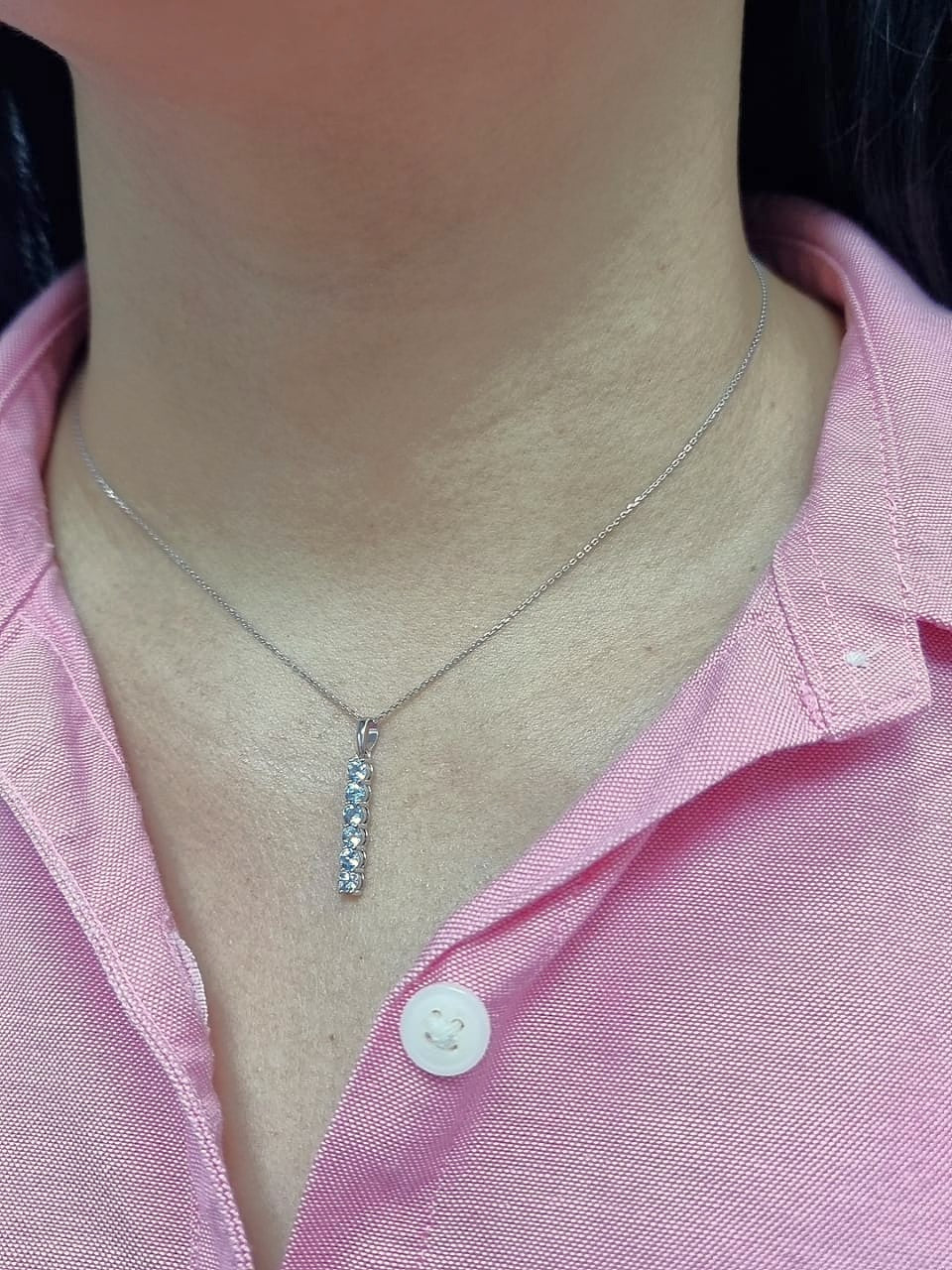 18k gold vertical bar pendant with six round-cut aquamarines totaling 0.72 carat