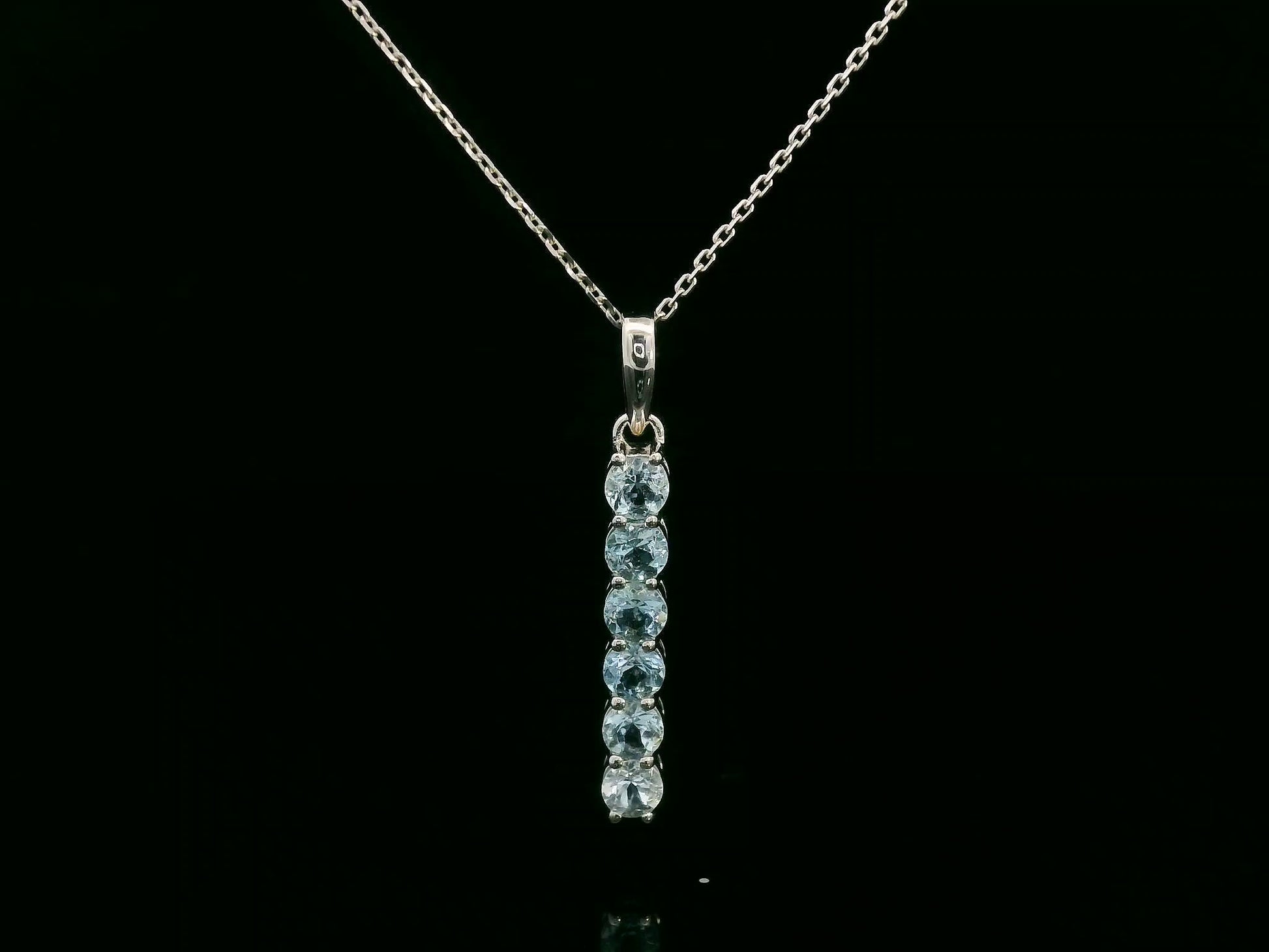 18k gold vertical bar pendant with six round-cut aquamarines totaling 0.72 carat