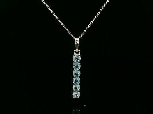 18k gold vertical bar pendant with six round-cut aquamarines totaling 0.72 carat