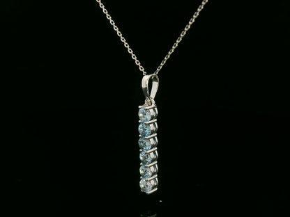 18k gold vertical bar pendant with six round-cut aquamarines totaling 0.72 carat