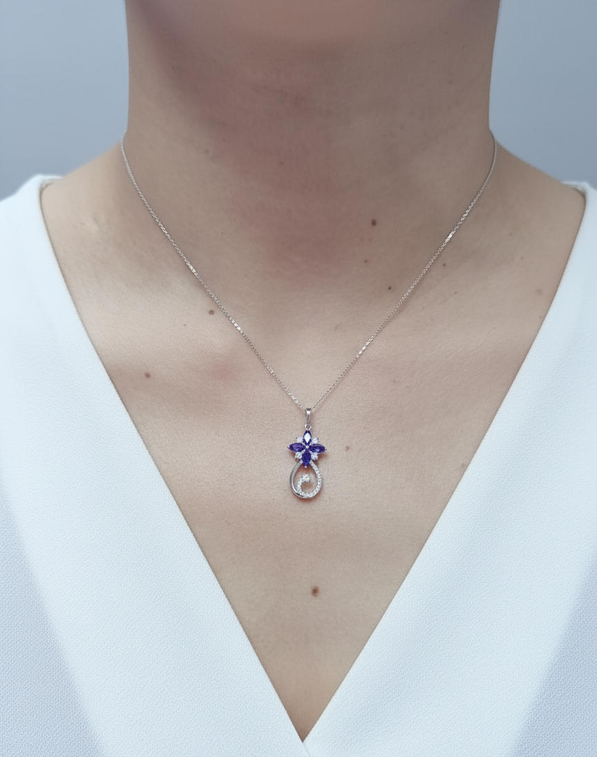 18K white gold Tanzanite and diamond floral paisley pendant featuring marquise-cut Tanzanites and pavé-set diamonds