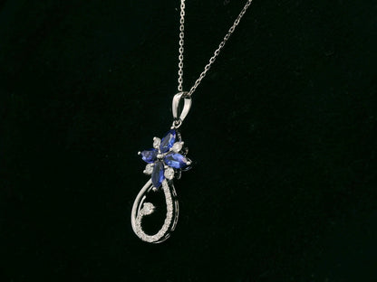 18K white gold Tanzanite and diamond floral paisley pendant featuring marquise-cut Tanzanites and pavé-set diamonds