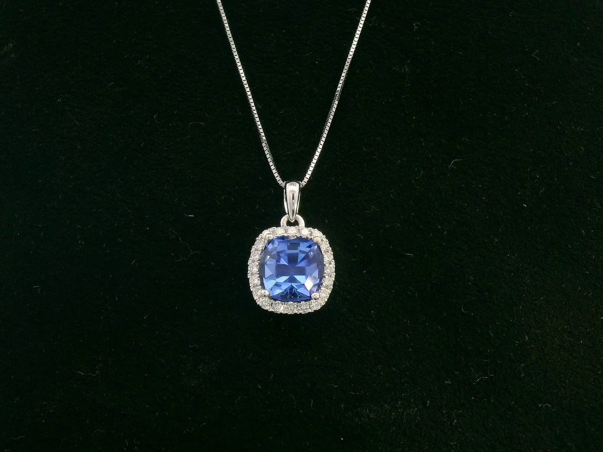 18K white gold Tanzanite and diamond halo pendant with cushion-cut 2.02 carat center stone