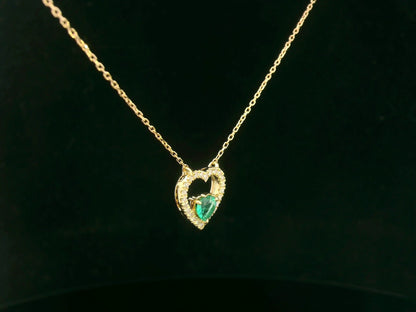 Heart-shaped emerald and diamond necklace in 18K yellow gold