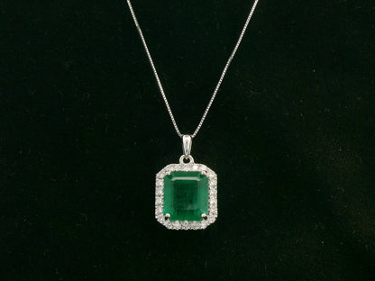 Emerald-cut emerald and diamond halo pendant in 18K white gold – Emirates Diamonds
