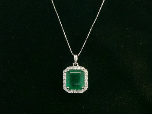Emerald-cut emerald and diamond halo pendant in 18K white gold – Emirates Diamonds