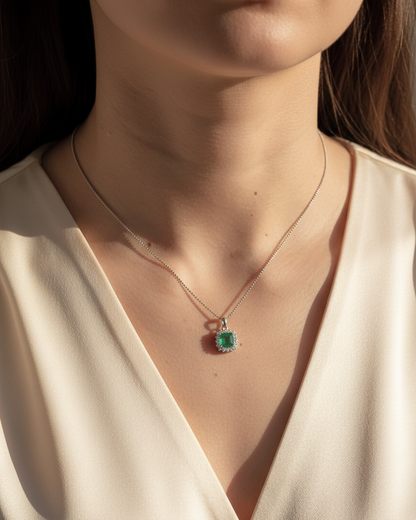 18K white gold emerald and diamond halo pendant by Emirates Diamonds