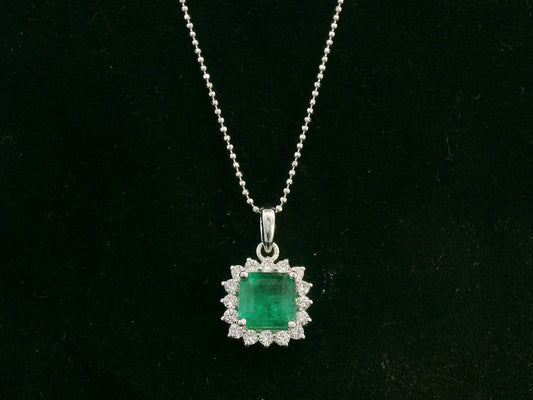 18K white gold emerald and diamond halo pendant by Emirates Diamonds