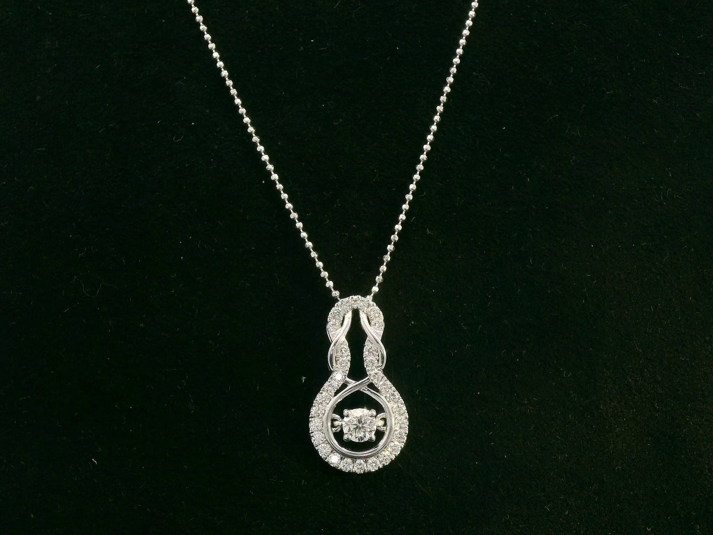 18K white gold diamond drop pendant with swirling design by Emirates Diamonds