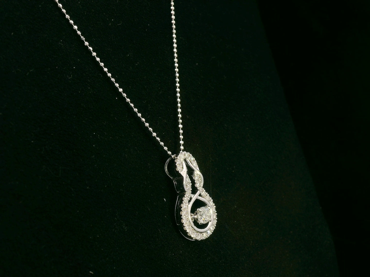 18K white gold diamond drop pendant with swirling design by Emirates Diamonds
