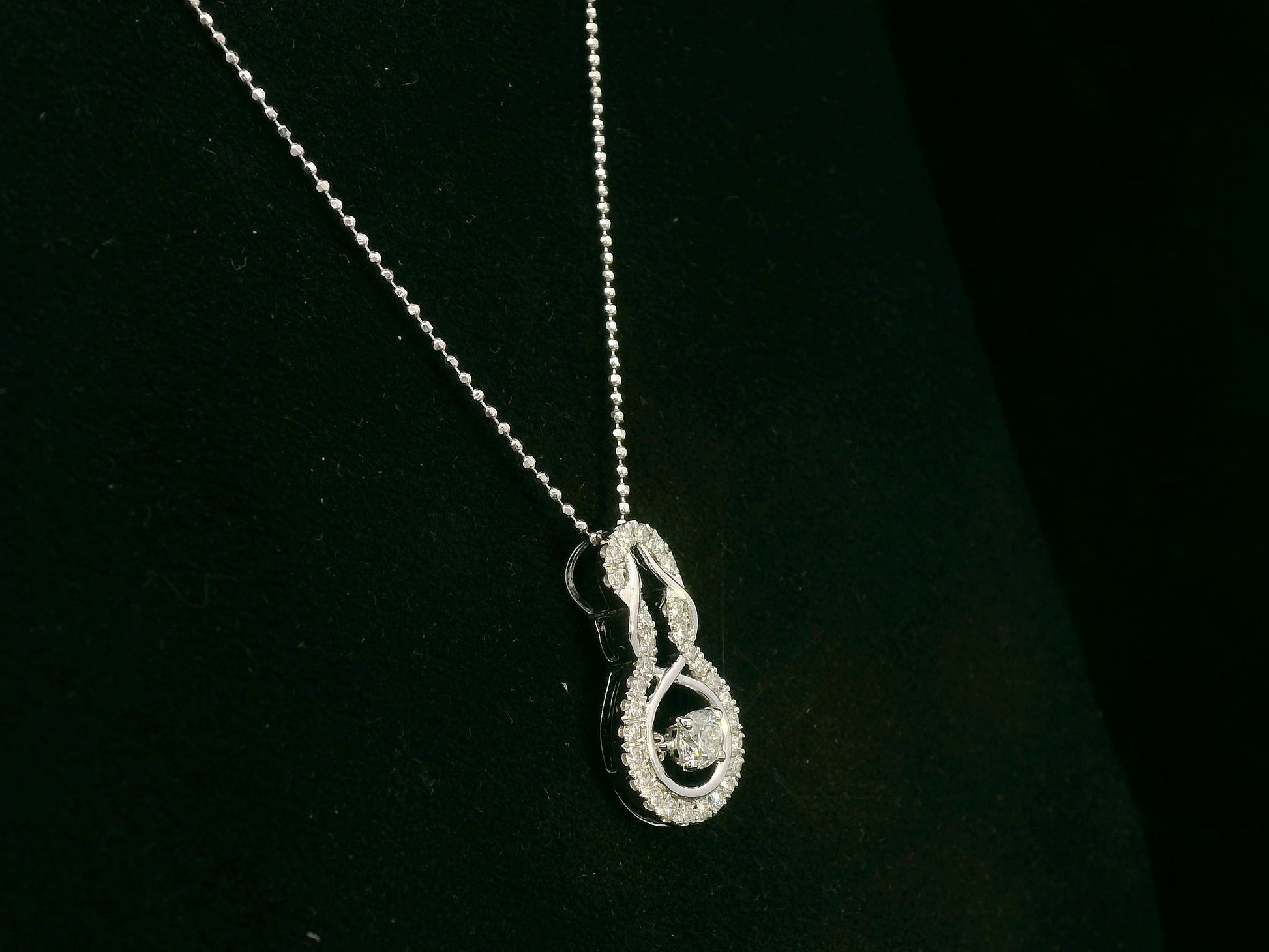 18K white gold diamond drop pendant with swirling design by Emirates Diamonds