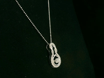18K white gold diamond drop pendant with swirling design by Emirates Diamonds