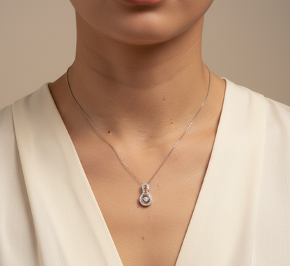 18K white gold diamond drop pendant with swirling design by Emirates Diamonds