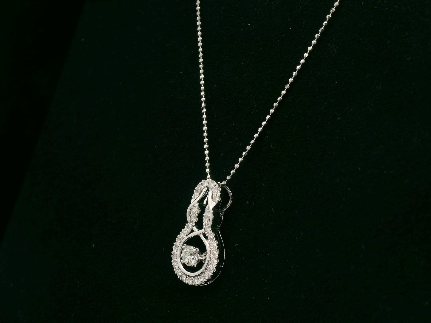 18K white gold diamond drop pendant with swirling design by Emirates Diamonds