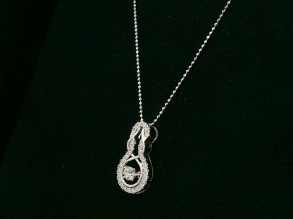 18K white gold diamond drop pendant with swirling design by Emirates Diamonds