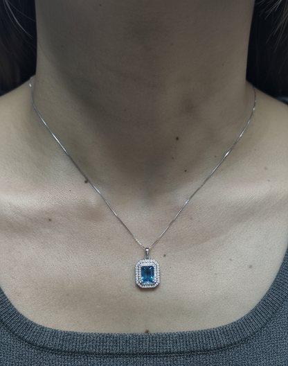 18K white gold Swiss blue topaz and diamond halo pendant with emerald-cut center stone – Emirates Diamonds