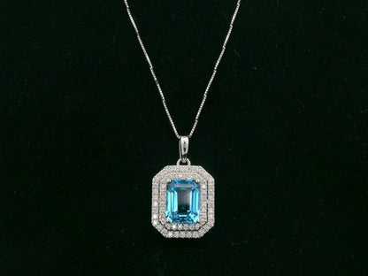 18K white gold Swiss blue topaz and diamond halo pendant with emerald-cut center stone – Emirates Diamonds