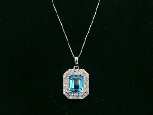 18K white gold Swiss blue topaz and diamond halo pendant with emerald-cut center stone – Emirates Diamonds