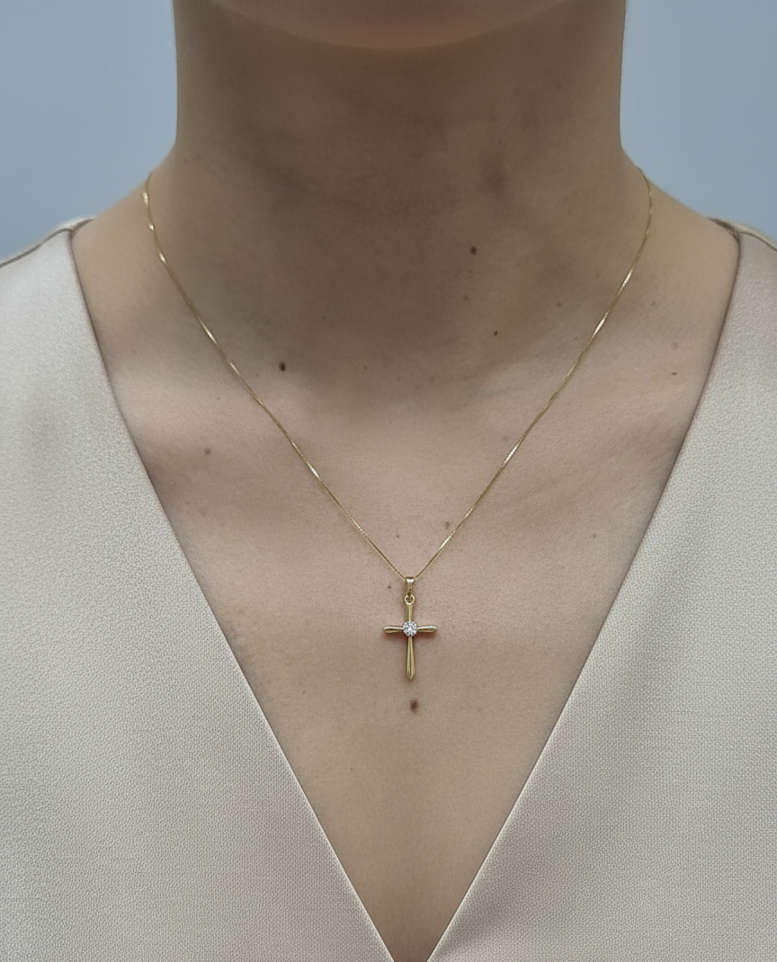 18K yellow gold diamond cross pendant necklace with minimalist design by Emirates Diamonds