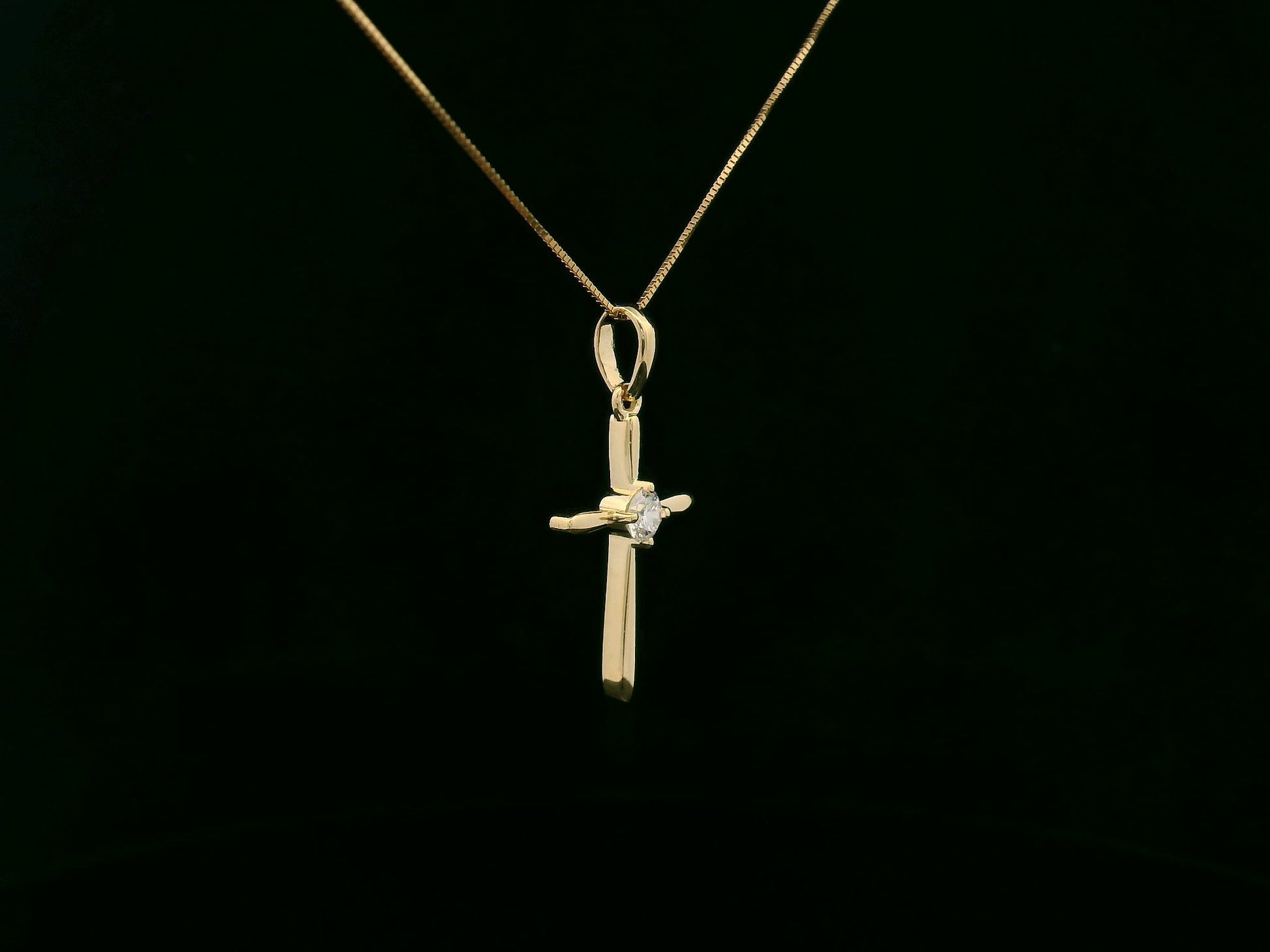 18K yellow gold diamond cross pendant necklace with minimalist design by Emirates Diamonds
