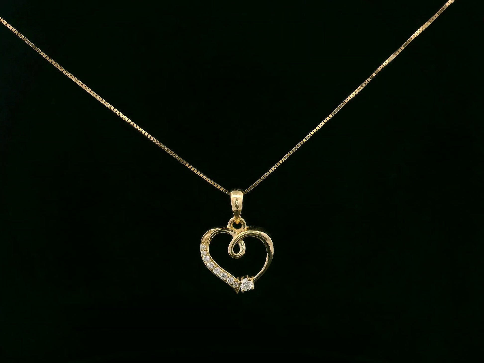 18K yellow gold diamond heart pendant with delicate open-heart design by Emirates Diamonds.