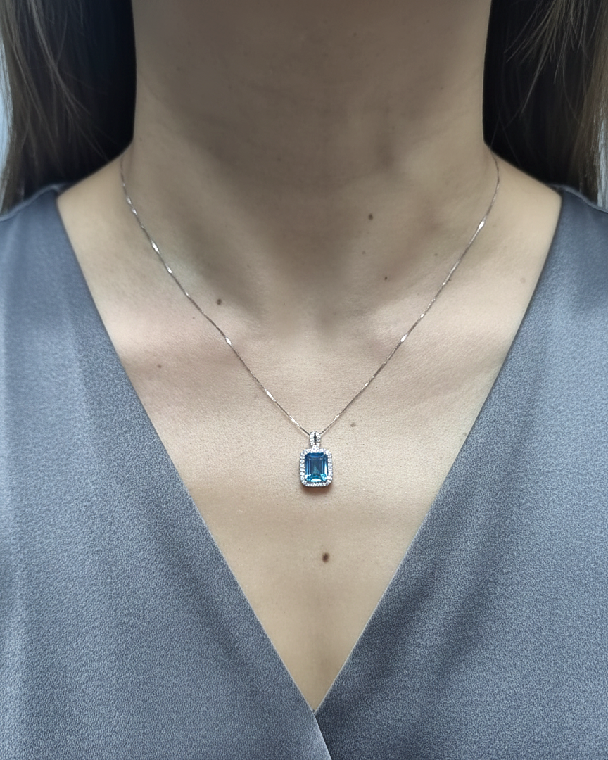 18K white gold Swiss blue topaz and diamond halo pendant necklace by Emirates Diamonds