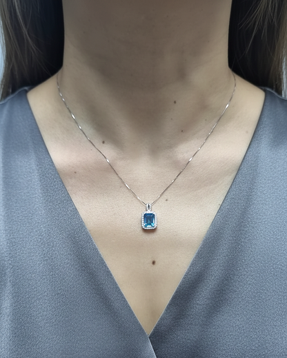 18K white gold Swiss blue topaz and diamond halo pendant necklace by Emirates Diamonds