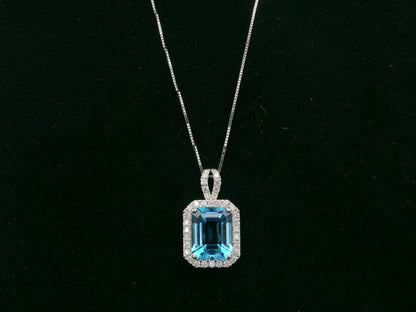 18K white gold Swiss blue topaz and diamond halo pendant necklace by Emirates Diamonds
