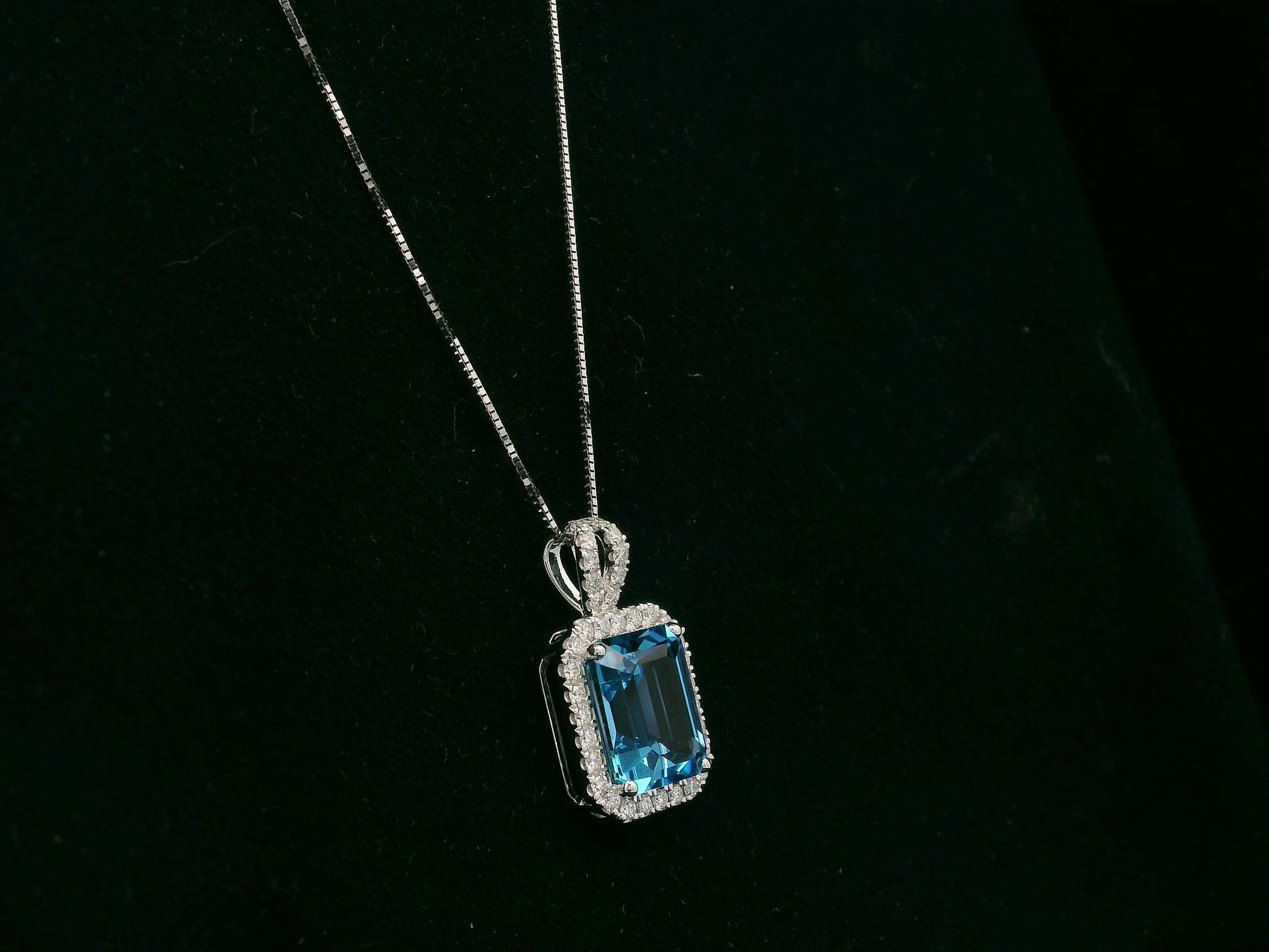 18K white gold Swiss blue topaz and diamond halo pendant necklace by Emirates Diamonds