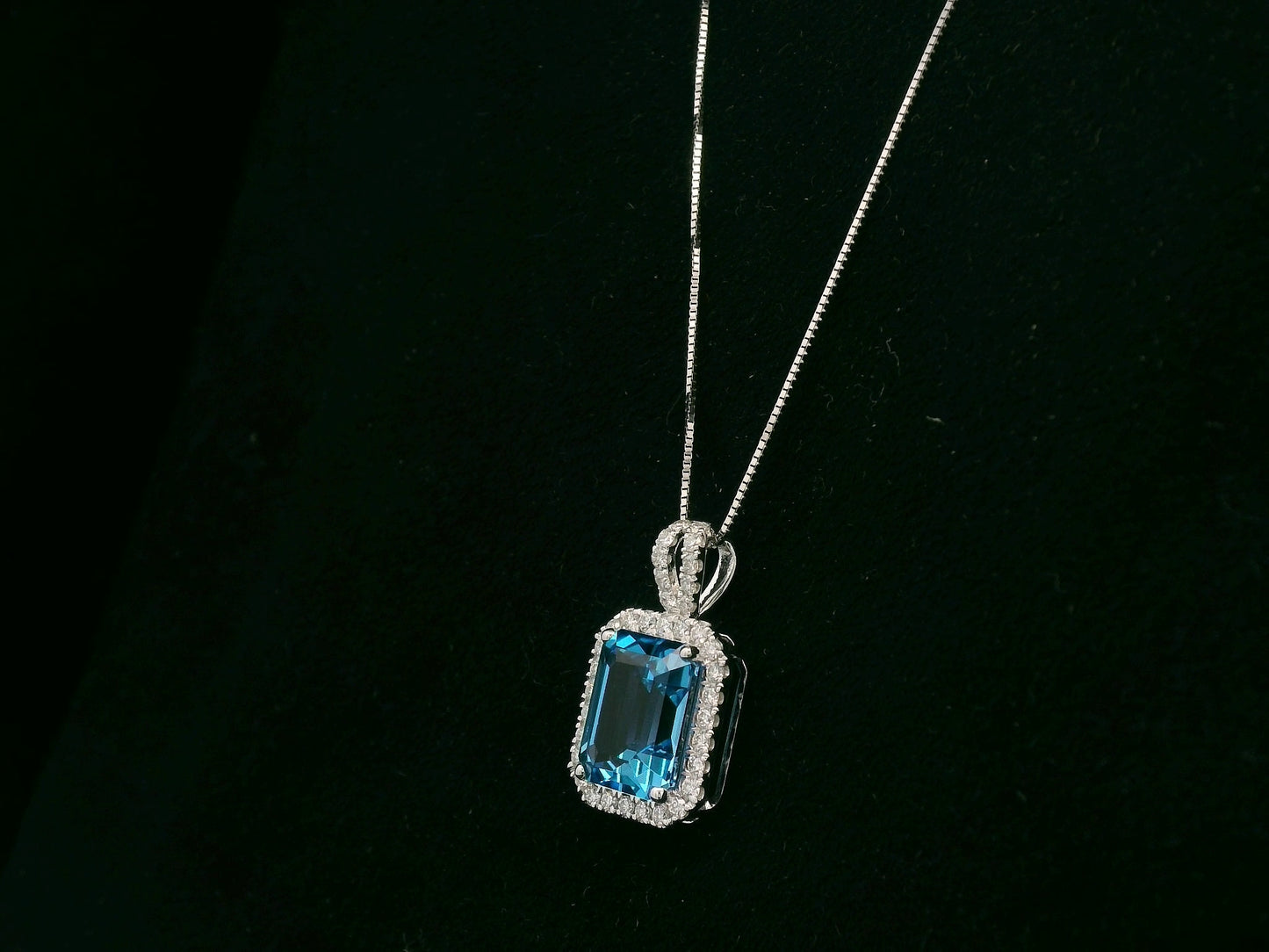 18K white gold Swiss blue topaz and diamond halo pendant necklace by Emirates Diamonds