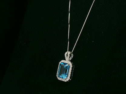 18K white gold Swiss blue topaz and diamond halo pendant necklace by Emirates Diamonds
