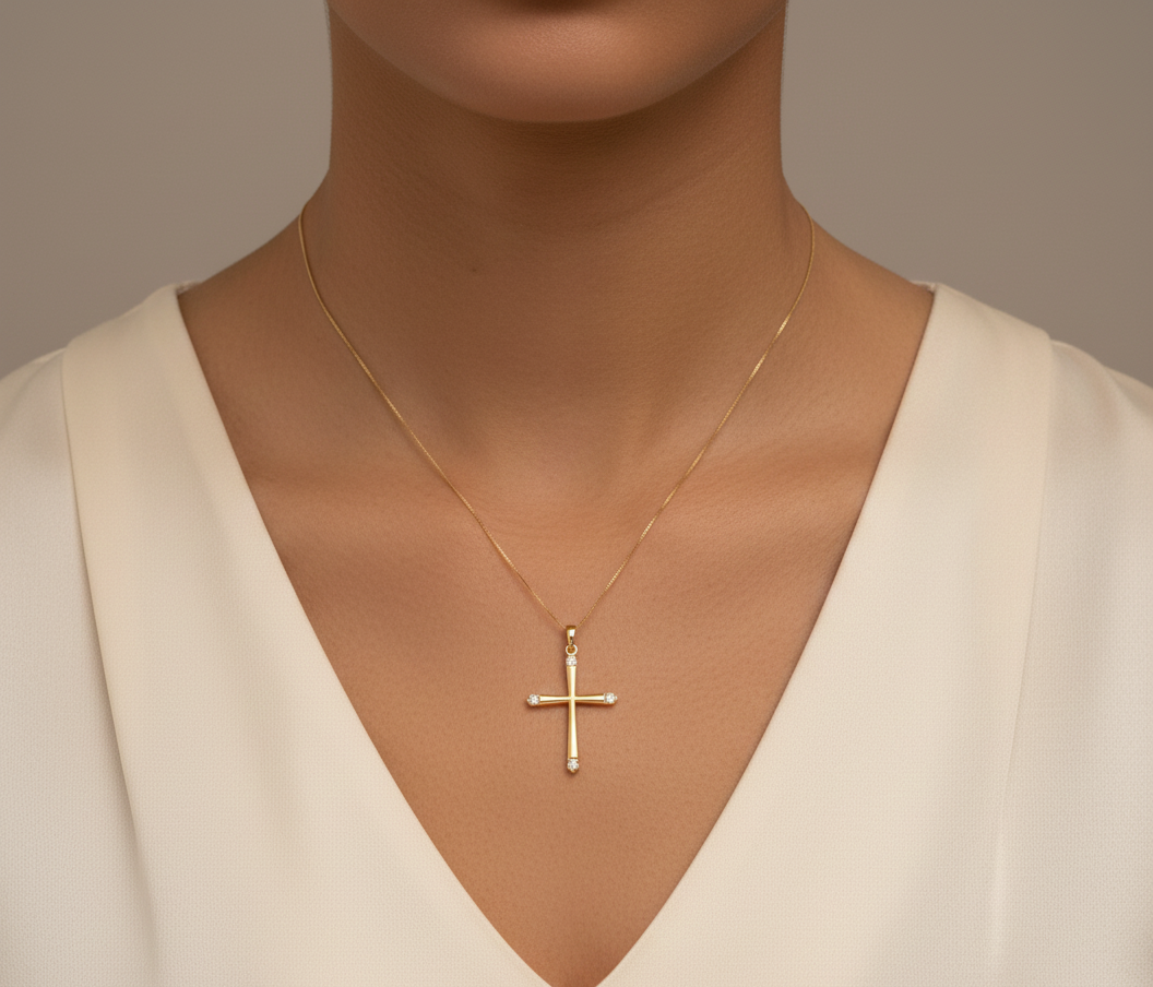 18K yellow gold diamond cross pendant with minimalist design by Emirates Diamonds.