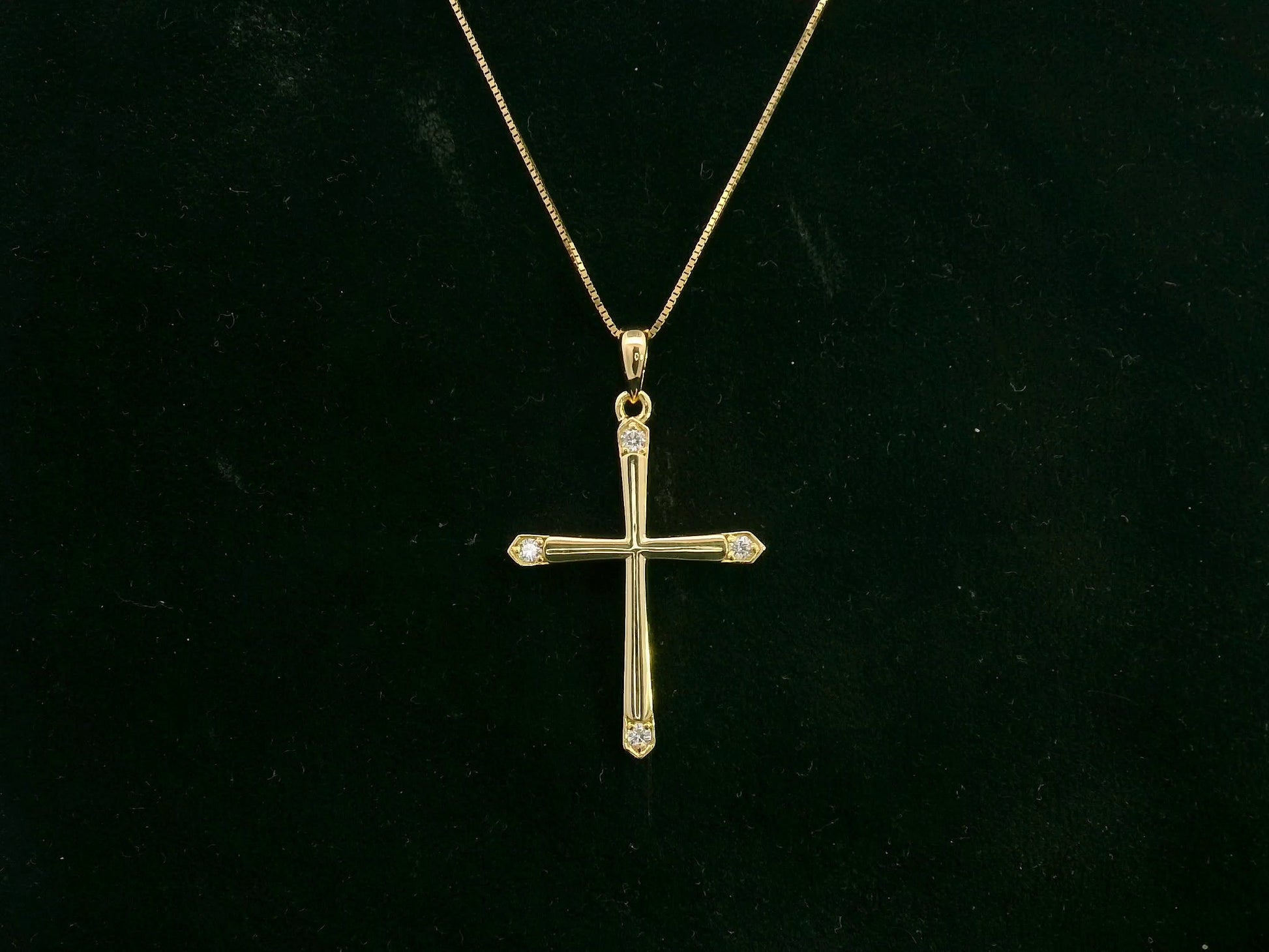 18K yellow gold diamond cross pendant with minimalist design by Emirates Diamonds.